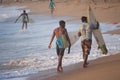 Kovalam, Chennai, Tamilnadu, India - Ã¢â¬Å½Ã¢â¬Å½August 9th Ã¢â¬Å½2021: Two young Indian surfers carrying surfboard and walking on the